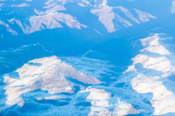 Fototapeta premium Beautiful mountain landscape from the cabin of a Boeing 777