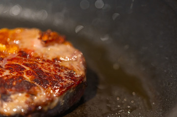 Pictures of a sliced fresh rump  steak with fat on the steak in a pan, which the steak cooks through in high heat