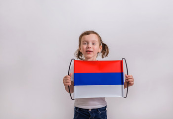 Funny girl with the Russian flag on a white background with place for text.