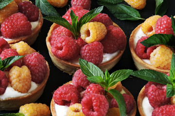 Tasty desserts with yellow and red raspberries. Keto desserts. Flat lay. Healthy desserts.