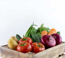 Basket with vegetables. Tomatoes, onions, labeling, potatoes, cucumbers and dill.Close-up.