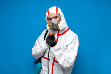 man in a chemical protective suit holds a spray bottle on a isolated background, epidemiologist, biologist, virologist, scientist