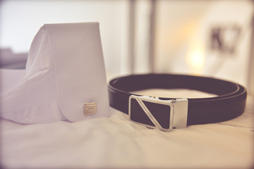 a belt, and a shirt with groom's cufflinks