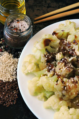 Cauliflower with soy sauce and spices on a plate. View from above. Diet food. Vegan lunch. Healthy eating
