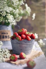 fresh strawberries on a table with wild flowers