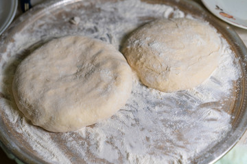 Fototapeta na wymiar Cooked dough lies on flour for further baking