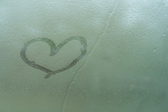 Image of heart on wet glass