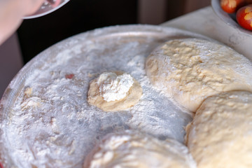 Fototapeta na wymiar Preparing a Dough for Baking Sweet Buns