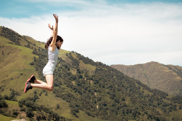 Woman jumping in the mountain