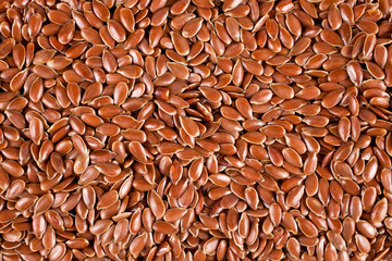 Background of brown flax (linen) seeds. Top view.