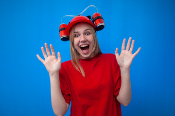 funny girl a fan in a red uniform and a beer hat is rooting for his team and screaming, a cheerleader is happy about the victory