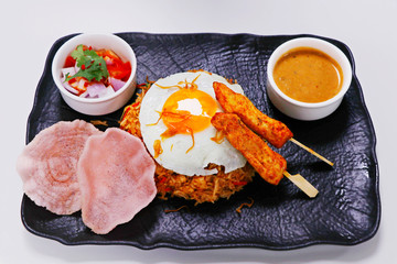 Nasi goreng, literally meaning fried rice in Indonesian, serve with chicken, prawns etc.