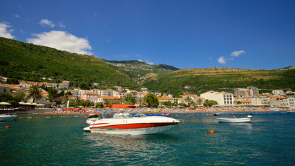 Fototapeta premium The boat stands in the sea opposite the resort town.
