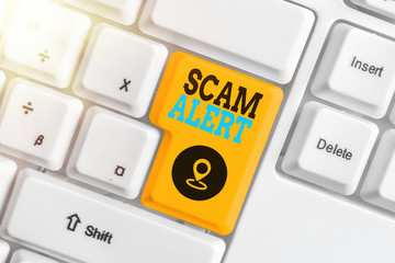 Writing note showing Scam Alert. Business concept for unsolicited email that claims the prospect of...