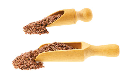 flax seeds spill out of a wooden scoop isolated on a white background .