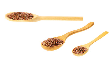 flaxseed on a wooden spoon isolated on white background .