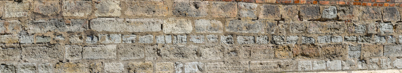 Ancient natural stone background. Gray grunge stone texture. Abstract rock detail. Panoramic view.