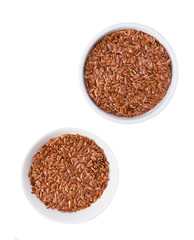 flaxseed in a  ceramic bowl  isolated on a white background, top view.