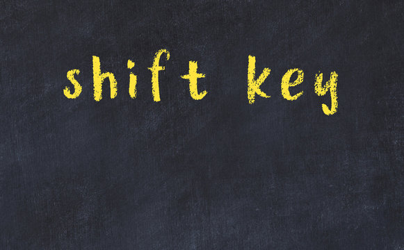 Black chalkboard with inscription shift key on in