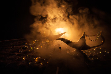 Silhouette of a man standing in the middle of the road on a misty night with giant Antique Aladdin...