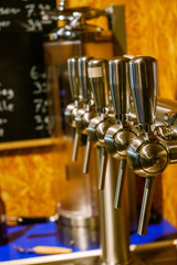 5 beer taps in a bar