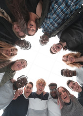 close up . group of cheerful young people standing in a circle