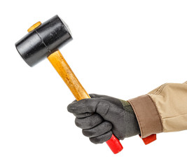 Black rubber hammer with wooden handle in worker hand in black protective glove and brown uniform isolated on white background