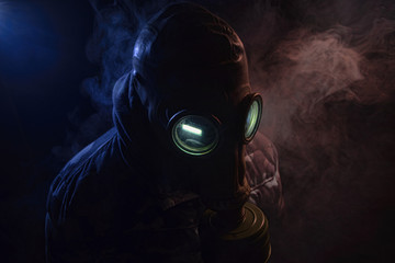 Gas mask with clouds of smoke on a dark background. Sign of radioactive contamination. Means for...