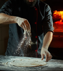 Close up chef making italian pizza cooked woodfired oven - obrazy, fototapety, plakaty