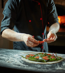 Close up chef making italian pizza cooked woodfired oven