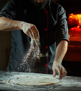 Close up chef making italian pizza cooked woodfired oven