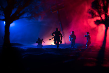 War Concept. Military silhouettes fighting scene on war fog sky background, World War Soldiers Silhouette Below Cloudy Skyline At night.