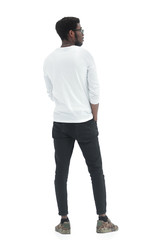 Fototapeta premium rear view. casual young man looking at a white blank screen