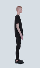 side view. casual student guy looking forward.