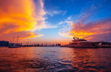 Fototapeta na wymiar sunset over the sea miami florida orange boat ocean water beautiful 