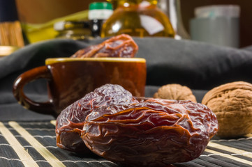 Big luxury dried date fruit on the bamboo mat, kurma ramadan kareem concept, close up.