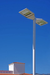 street flood light on blue sky with a part of an office building in the background