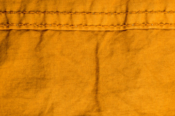 clothing items stonewashed cotton fabric texture with seams, clasps, buttons and rivets, macro