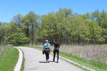 Woman pointing at something to another woman on the North Branch Trail at Miami Woods in Morton Grove, Illinois