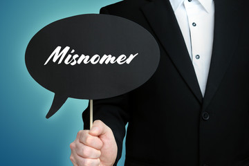 Misnomer. Lawyer (Man) holds the sign of a speech bubble in his hand. Text on the label. Symbol of...