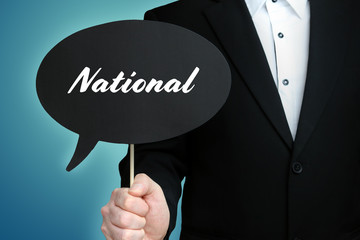 National. Lawyer (Man) holds the sign of a speech bubble in his hand. Text on the label. Symbol of law, justice, judgement