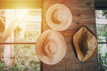 Straw hats hanging on the interior wall of the rural house
