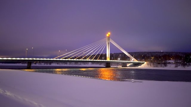 Kemijoki river in Rovaniemi with Ounaskoski Railway bridge and Lumberjack's Candle Bridge during winter, Finland.