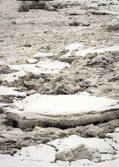 Close up of big pieces of ice (floes) breaking, cracking and melting in Knik Arm, north of Anchorage, Alaska. Winter landscape. Taken from Port of Anchorage Small Boat Launch. Coast of the city.