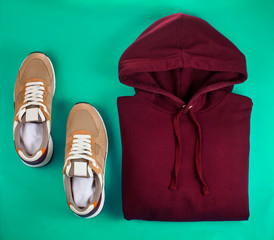 Sneakers with hoodie on a green background.