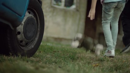 A Kidnapper taking out the child from the ven and taking it into a house. While walking, a girl is dropping the toy from her hands.  Child abduction scene. - Powered by Adobe