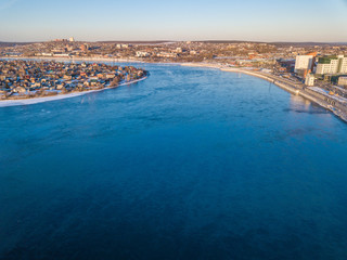 Fototapeta premium Aerial view of Angara river flows through city of Irkutsk the largest cities in Siberia, Russia. The Angara is the only river flowing from lake Baikal.