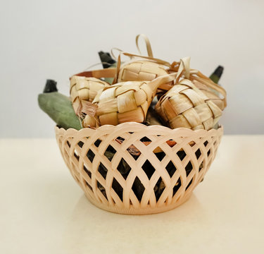 Popular Malay traditional food, Ketupat rice and Lontong Nasi Impit. Ketupats, a natural rice casing made from young coconut leaves for cooking rice on a white background.