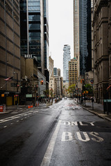 Fototapeta na wymiar New York street. Manhattan downtown street. Empty streets of NYC. Rainy city. Sky rise buildings. Brown brick skyscrapers of New York City. 