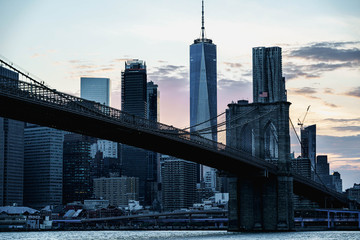 Obraz premium New York night panorama. Brooklyn Bridge and New York City skyline. Manhattan skyline. Skyscrapers buildings. New York City night lights. 
